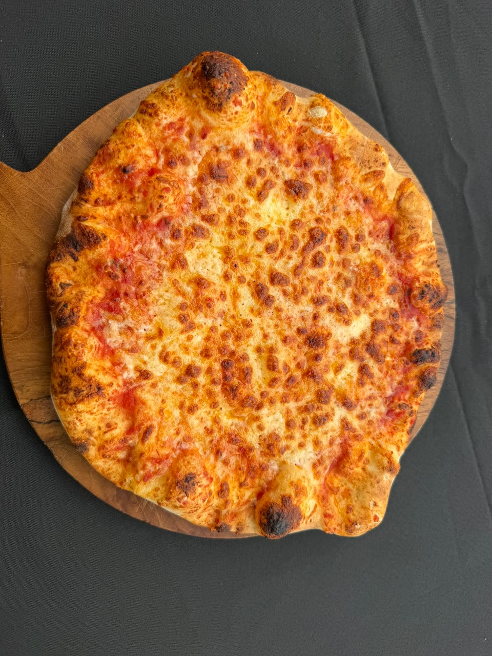 Xanders freshly cooked pizza on a serving board