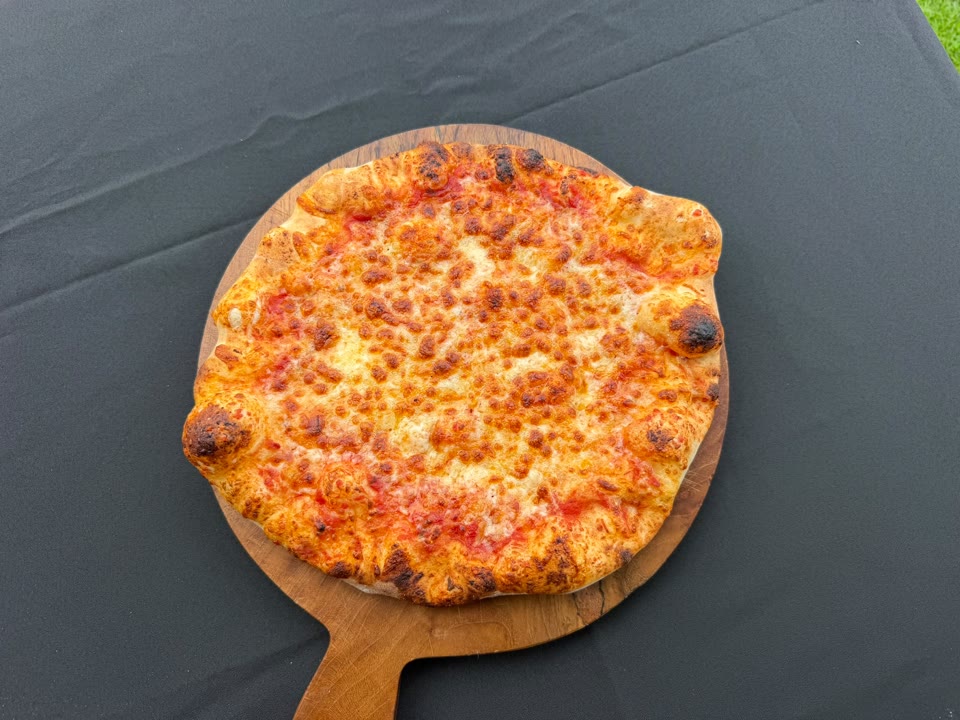 Xanders freshly cooked pizza on a serving board
