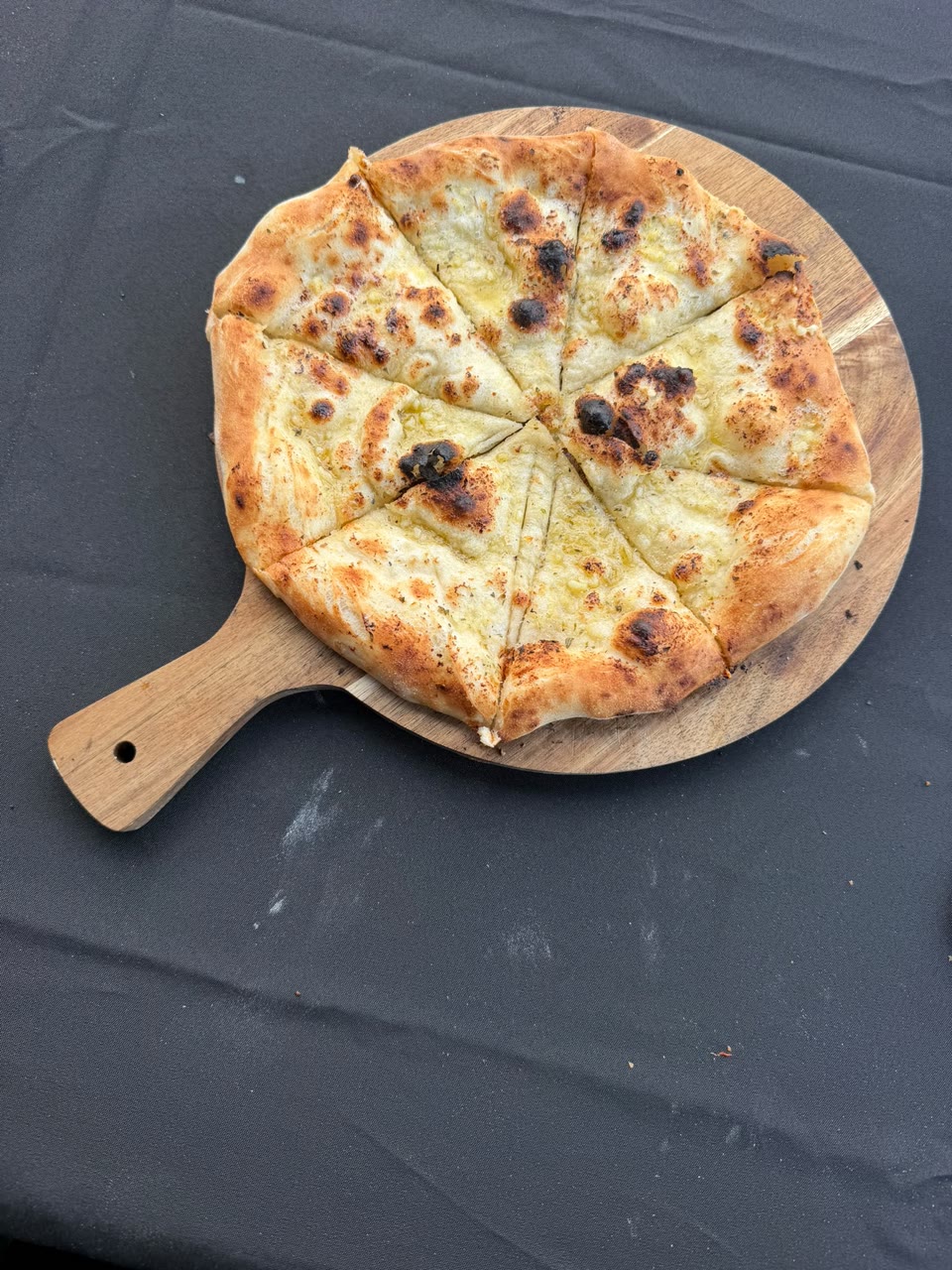 Xanders freshly cooked pizza on a serving board