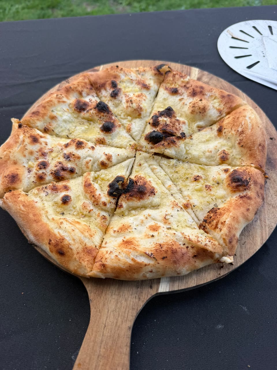 Xanders freshly cooked pizza on a serving board