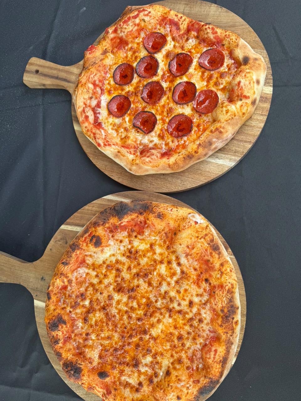Xanders freshly cooked pizza on a serving board