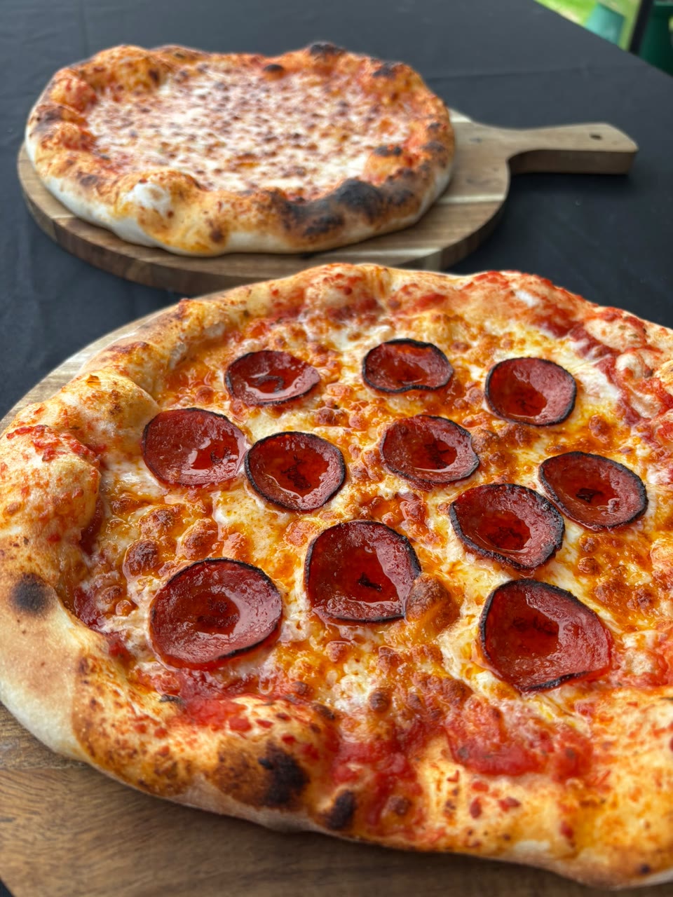 Xanders freshly cooked pizza on a serving board