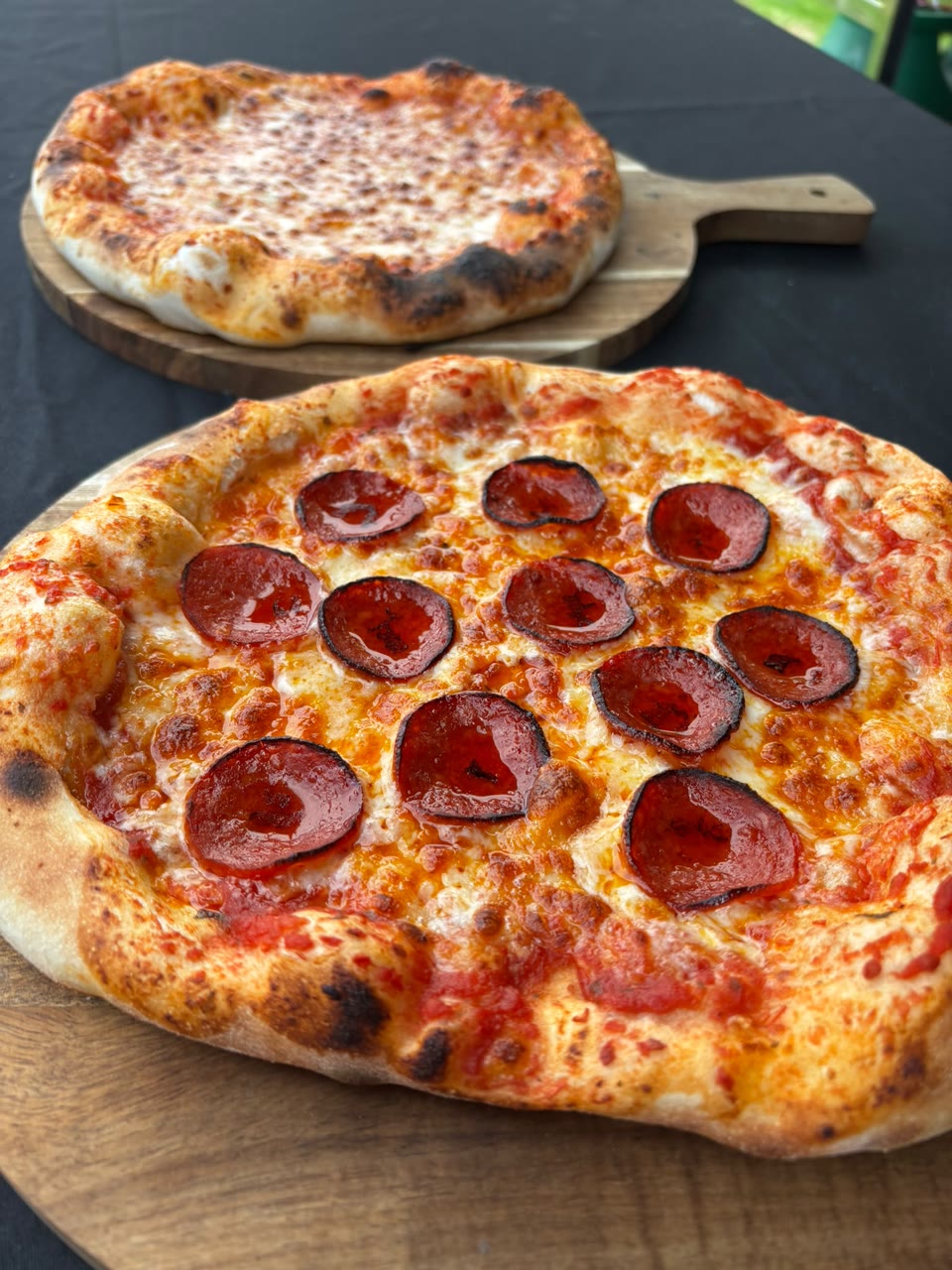 Pepperoni and cheese pizzas ready to serve