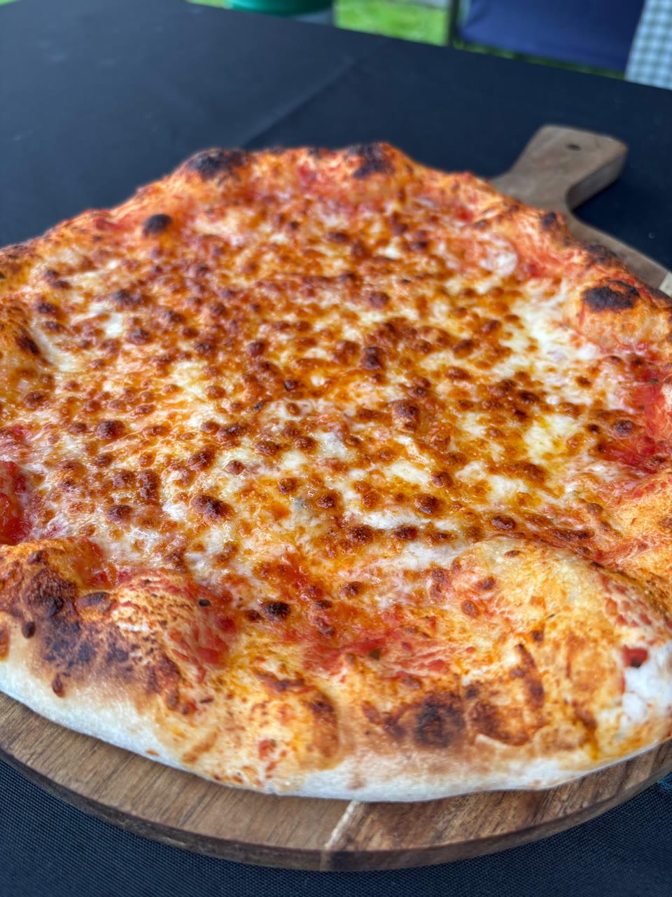 Xanders freshly cooked pizza on a serving board