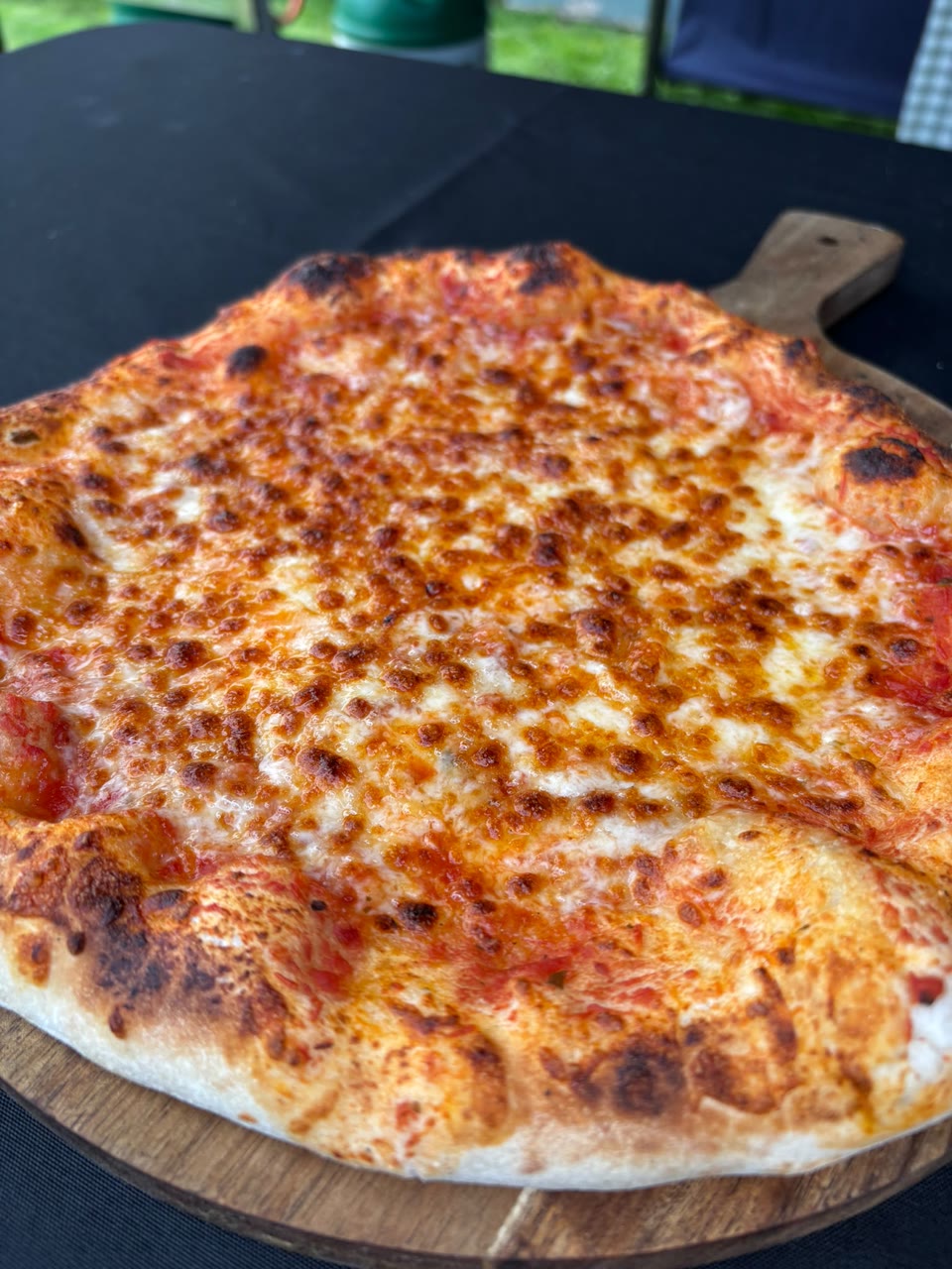 Xanders freshly cooked pizza on a serving board