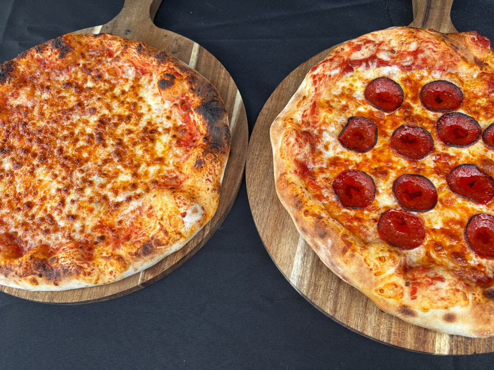 Xanders freshly cooked pizza on a serving board