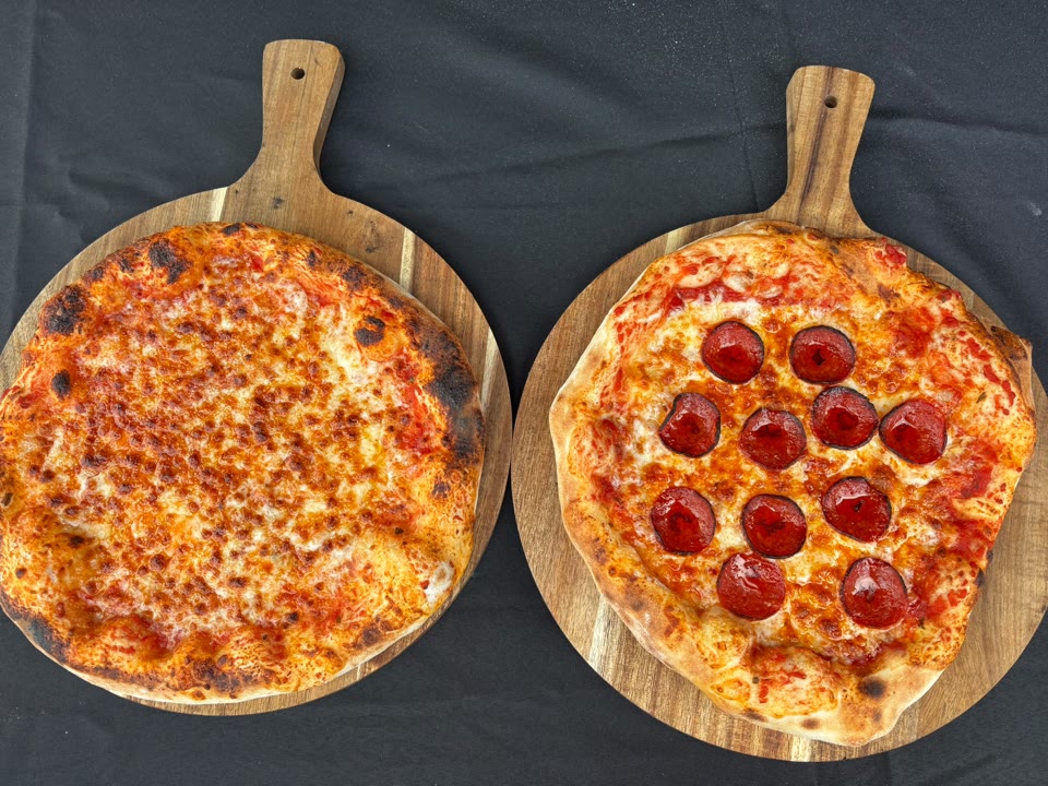 Xanders freshly cooked pizza on a serving board