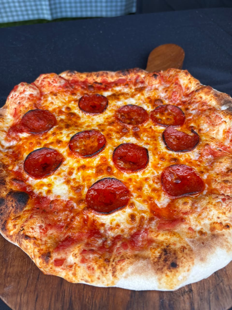 Xanders freshly cooked pizza on a serving board
