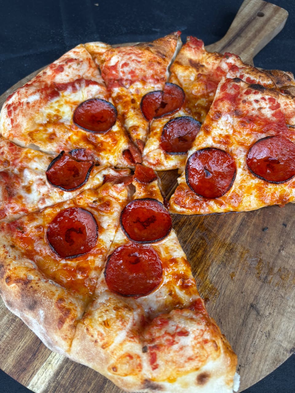 Xanders freshly cooked pizza on a serving board