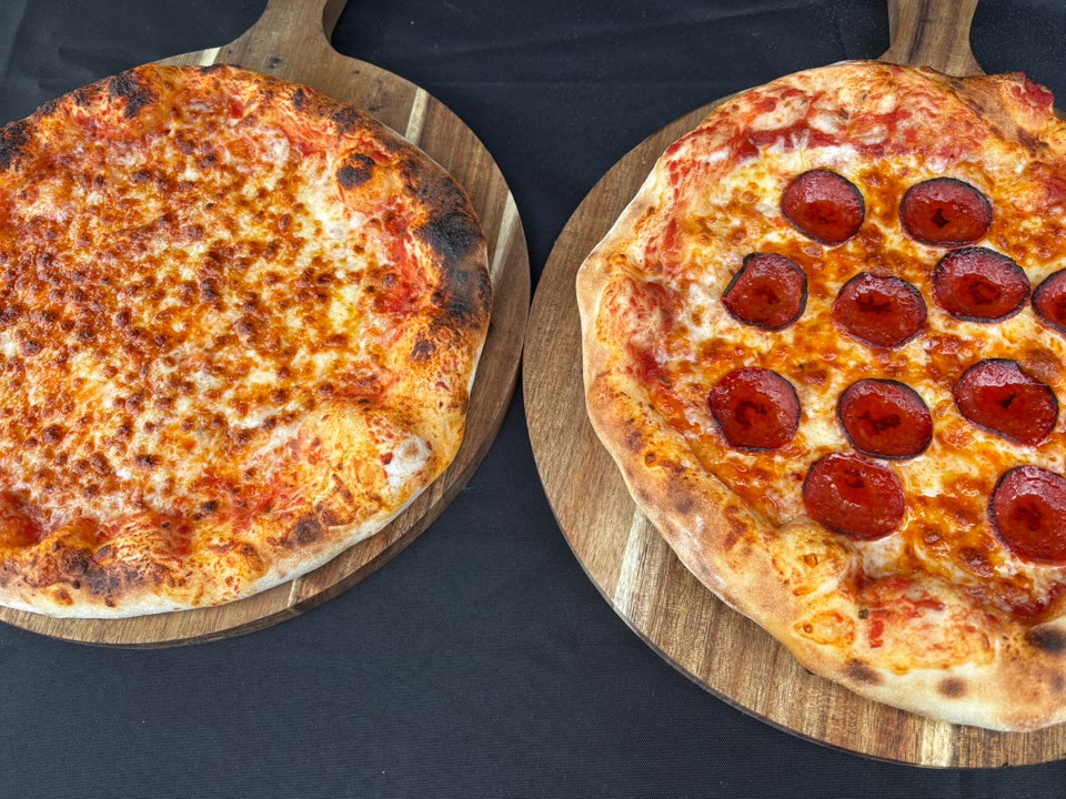 Xanders freshly cooked pizza on a serving board