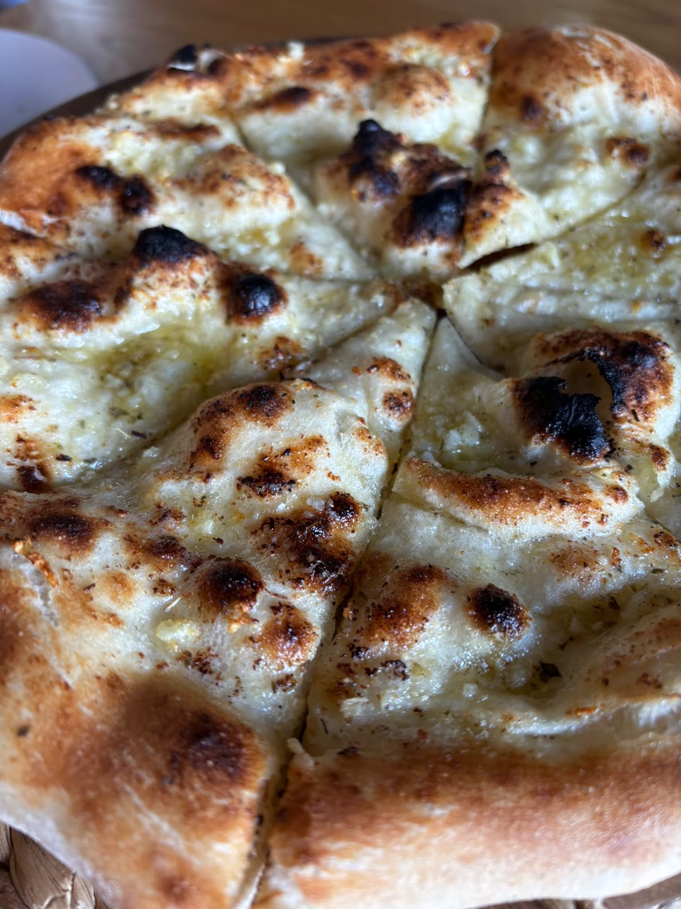 Xanders freshly cooked pizza on a serving board