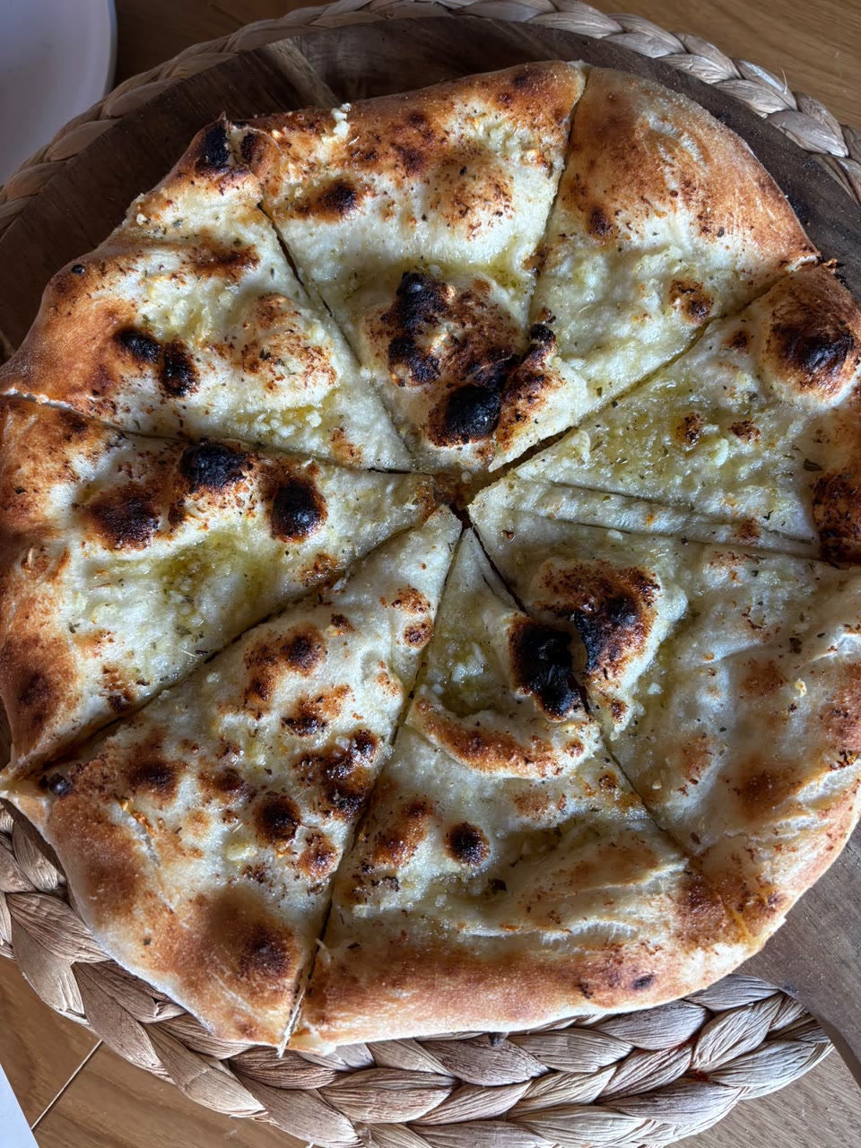 Xanders freshly cooked pizza on a serving board