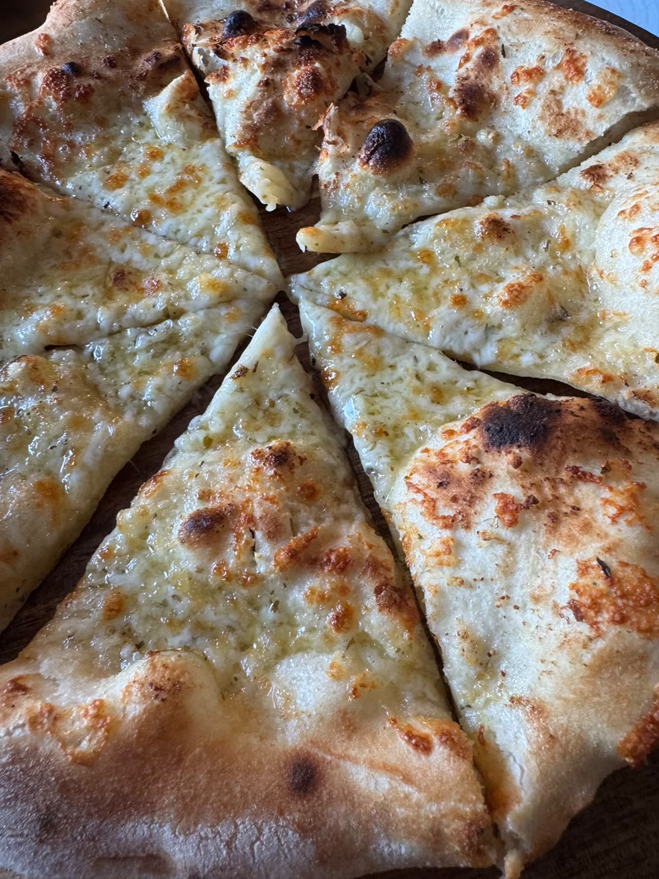 Xanders freshly cooked pizza on a serving board