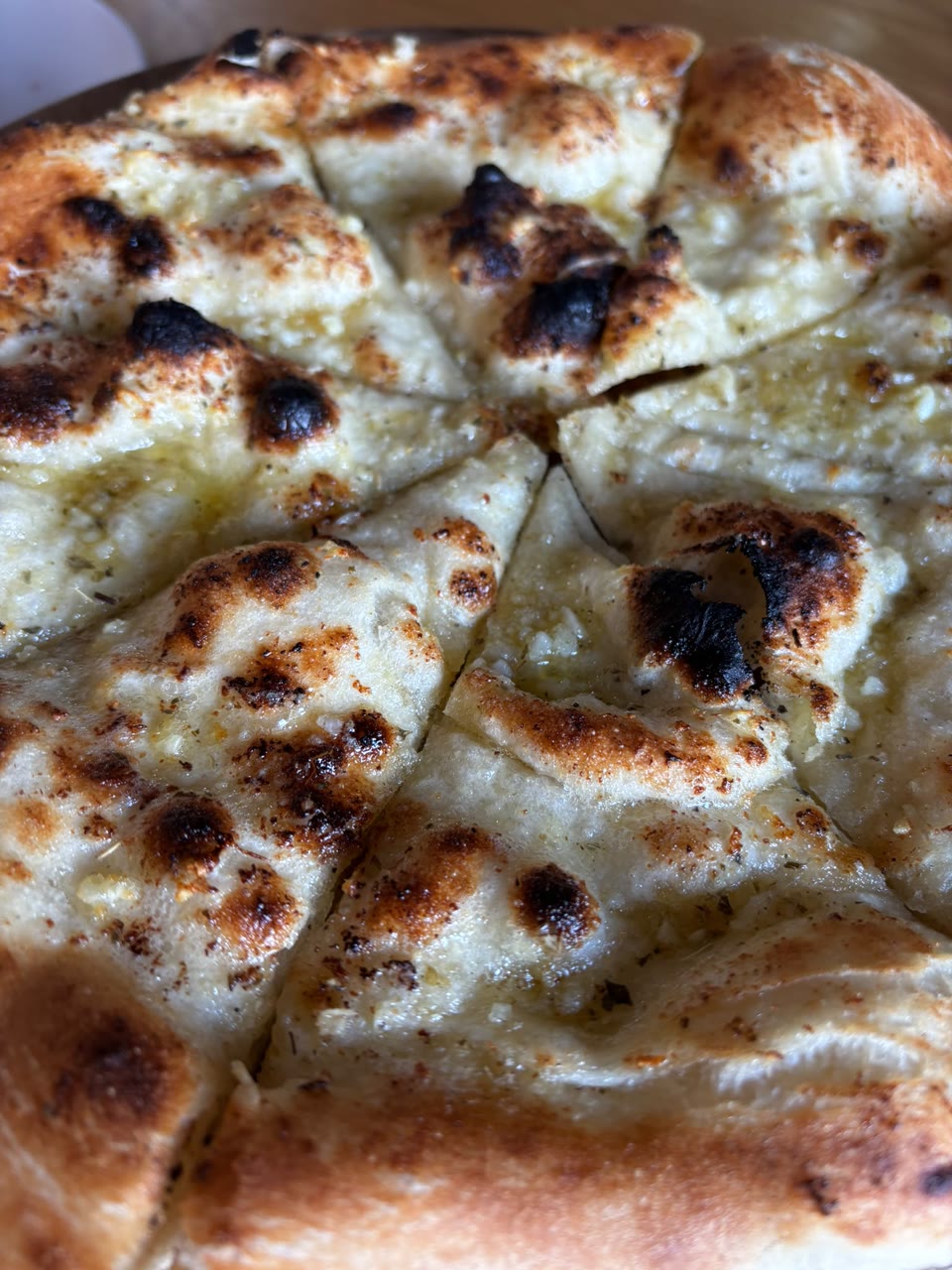 Xanders freshly cooked pizza on a serving board